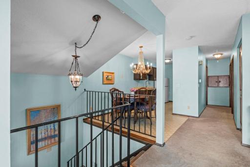 Showing the top of the stairs after entering the condo