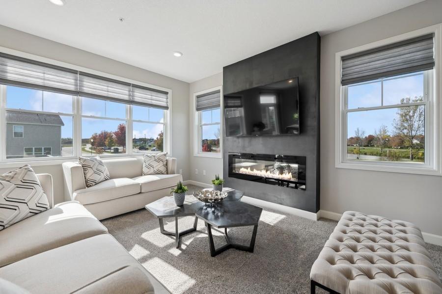 (Photo of a decorated model, actual features will vary) The family room features a stunning electric fireplace.