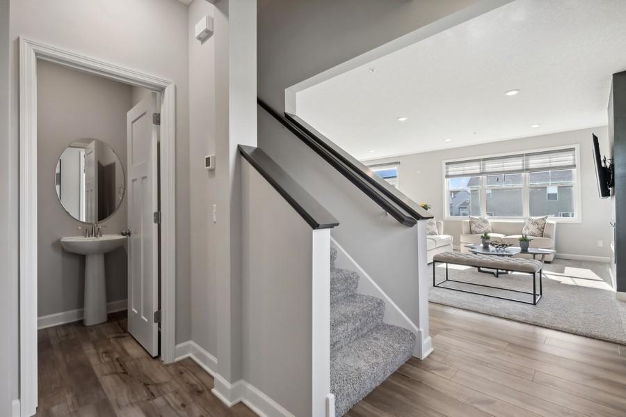 (Photo of a decorated model, actual features will vary) Right off the stairs to the upper level is the powder bath.