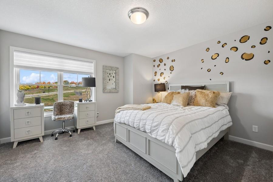 One of two spacious secondary bedrooms. (Photo of a decorated model, actual features will vary)