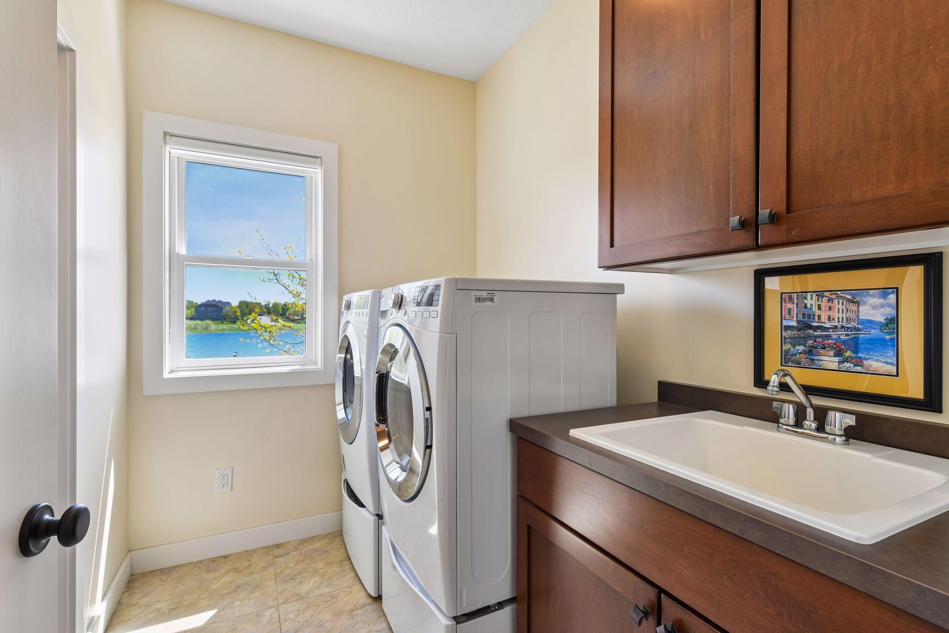 The primary bedroom suite's also connects to the laundry room. Note the beautiful water view beyond.