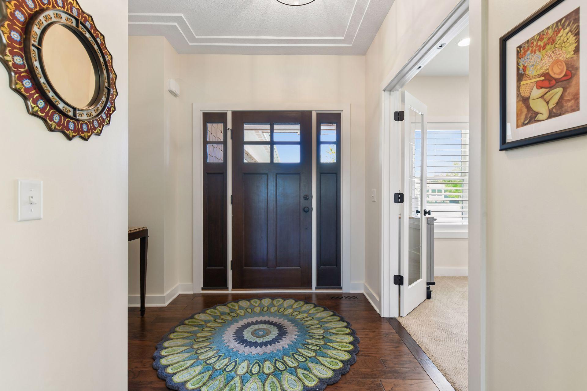 A gracious foyer greets your guests. The office/den is located to the right, through the French doors.