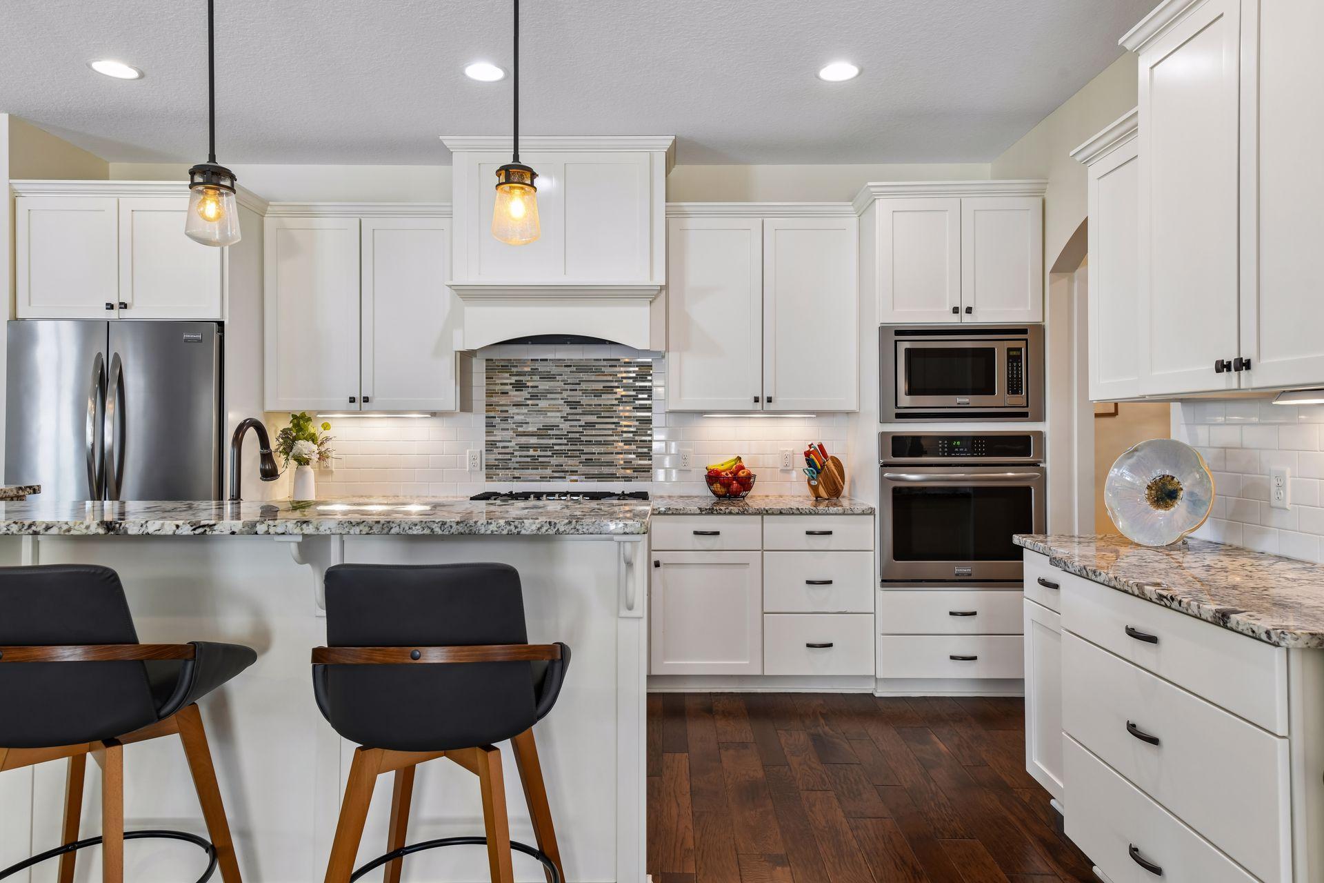 The backsplash and accent over the cooktop are tiled in neutral colors in order to coordinate with anyone's decor.