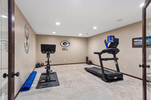 Also located on the lower level, through French doors, is a multi-purpose space that could be used as a theater room, exercise area (as shown), craft room or more.