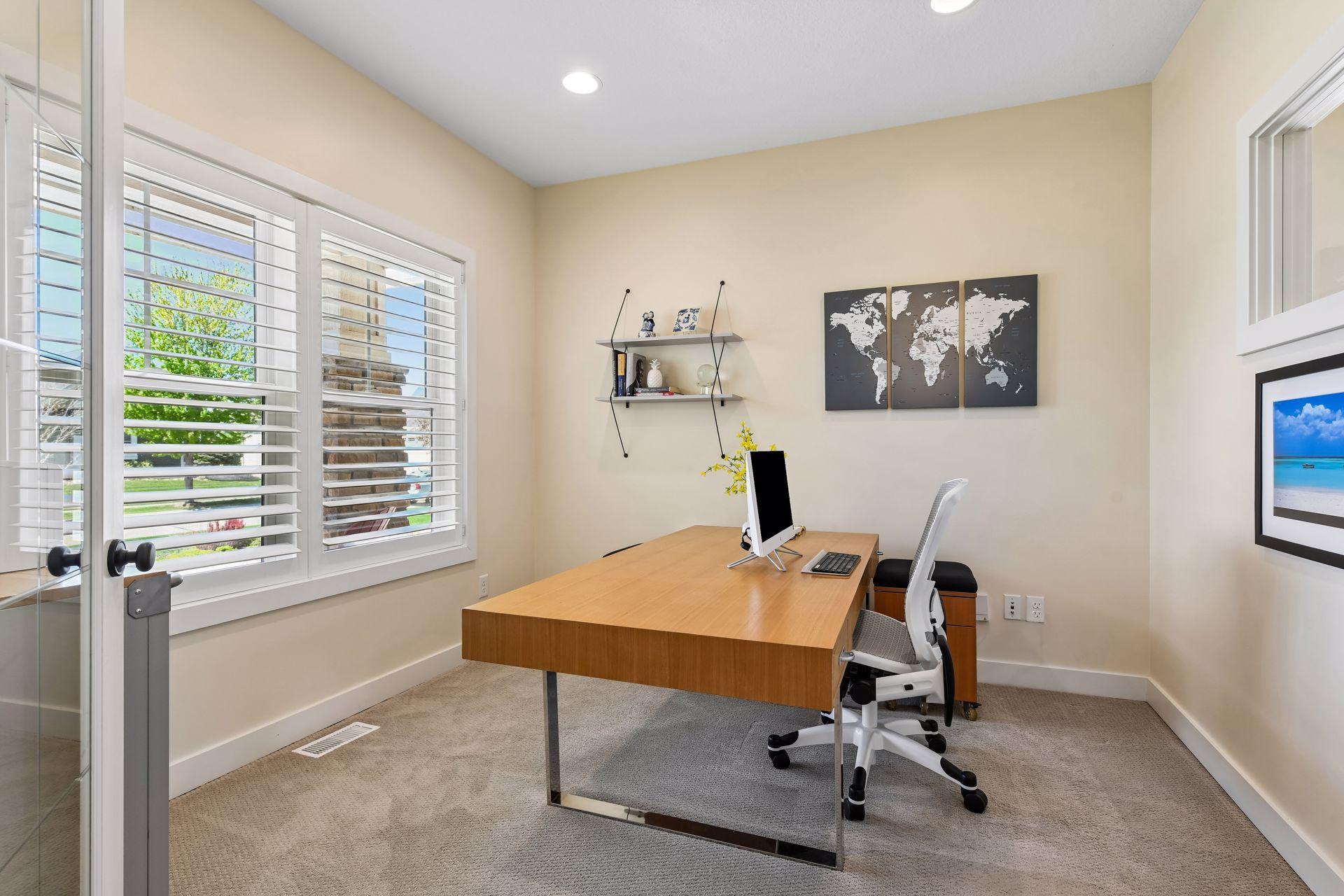 The office/den features adjustable plantation shutters on the window that faces west.