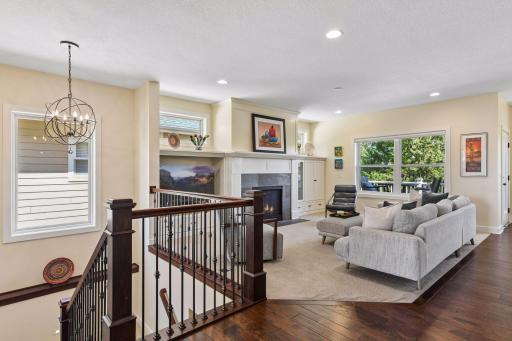 The dark wood floors and detailed banister add elegance to the space.