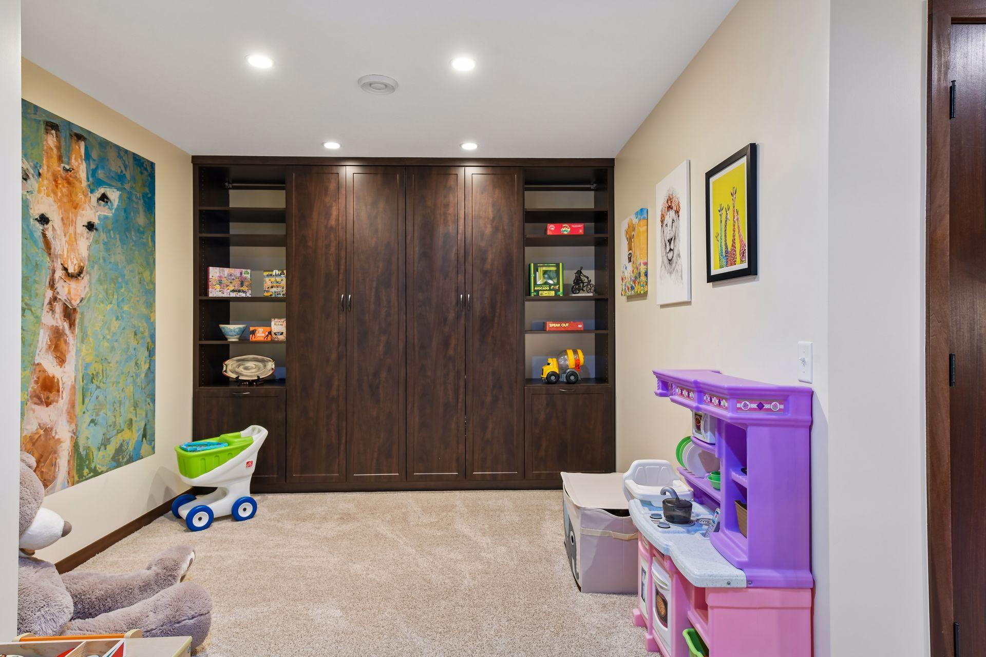Around the corner from the wet bar is a bonus area featuring even more built-in cabinetry. Currently furnished as a children's play area, this area could easily accommodate an office, music room or craft area.