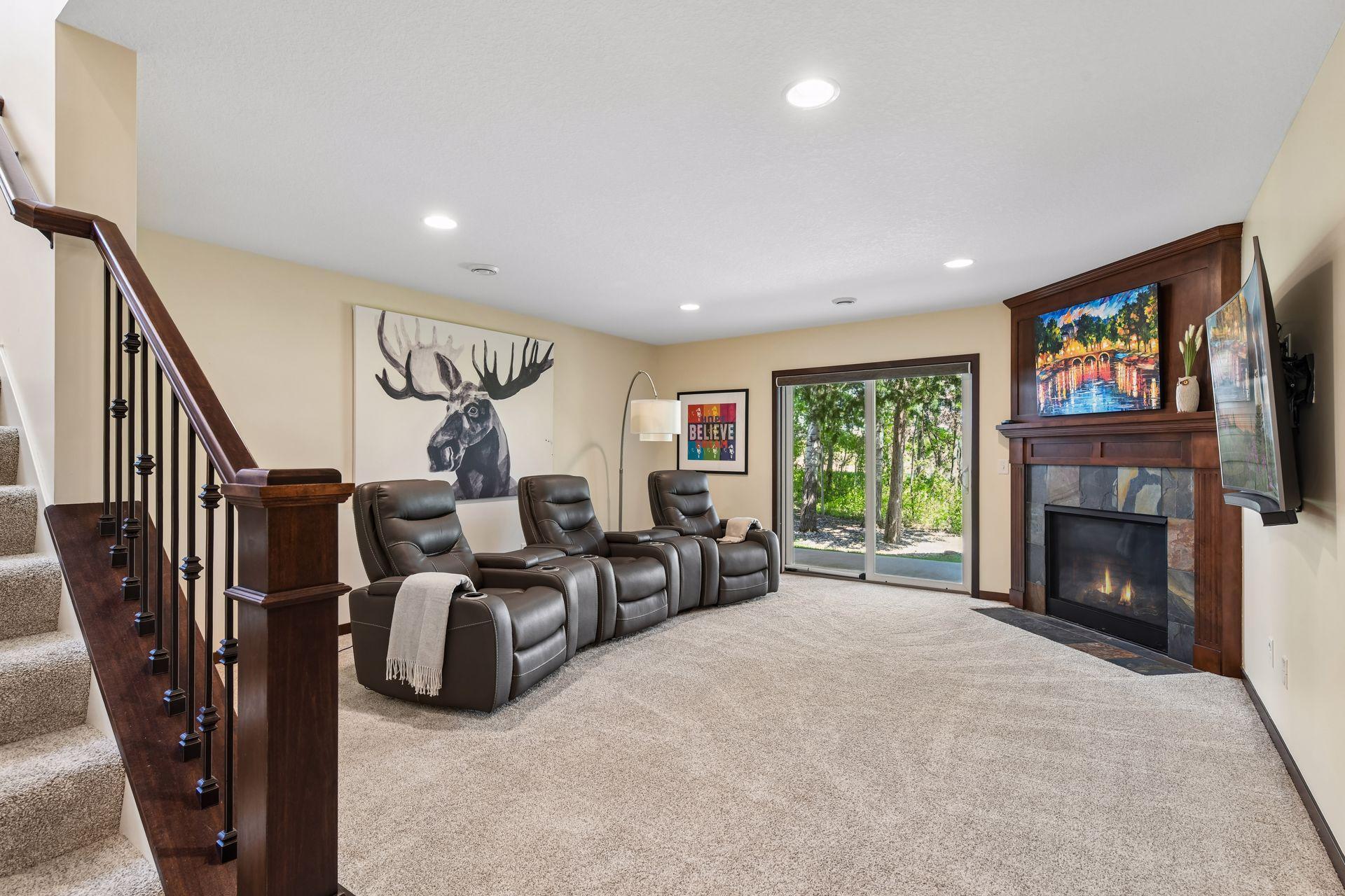 At the foot of the stairs is a family room which the current homeowner has furnished as a media room. The leather seating was purchased in 2025, has been seldom used, and is available for sale.