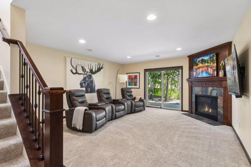 At the foot of the stairs is a family room which the current homeowner has furnished as a media room. The leather seating was purchased in 2025, has been seldom used, and is available for sale.