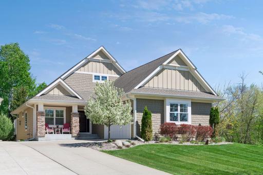 This terrific executive villa features a main floor primary bedroom suite and views of nature