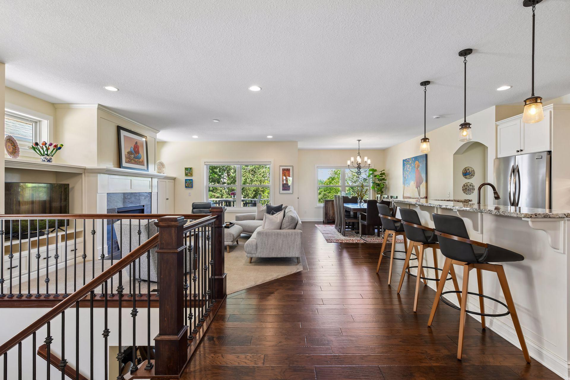 The main floor foyer opens to the great room, kitchen and dining room. An elevated deck is located beyond the large windows. Unlike most homes in this neighborhood, the homeowner enjoys views of nature from its primary windows.