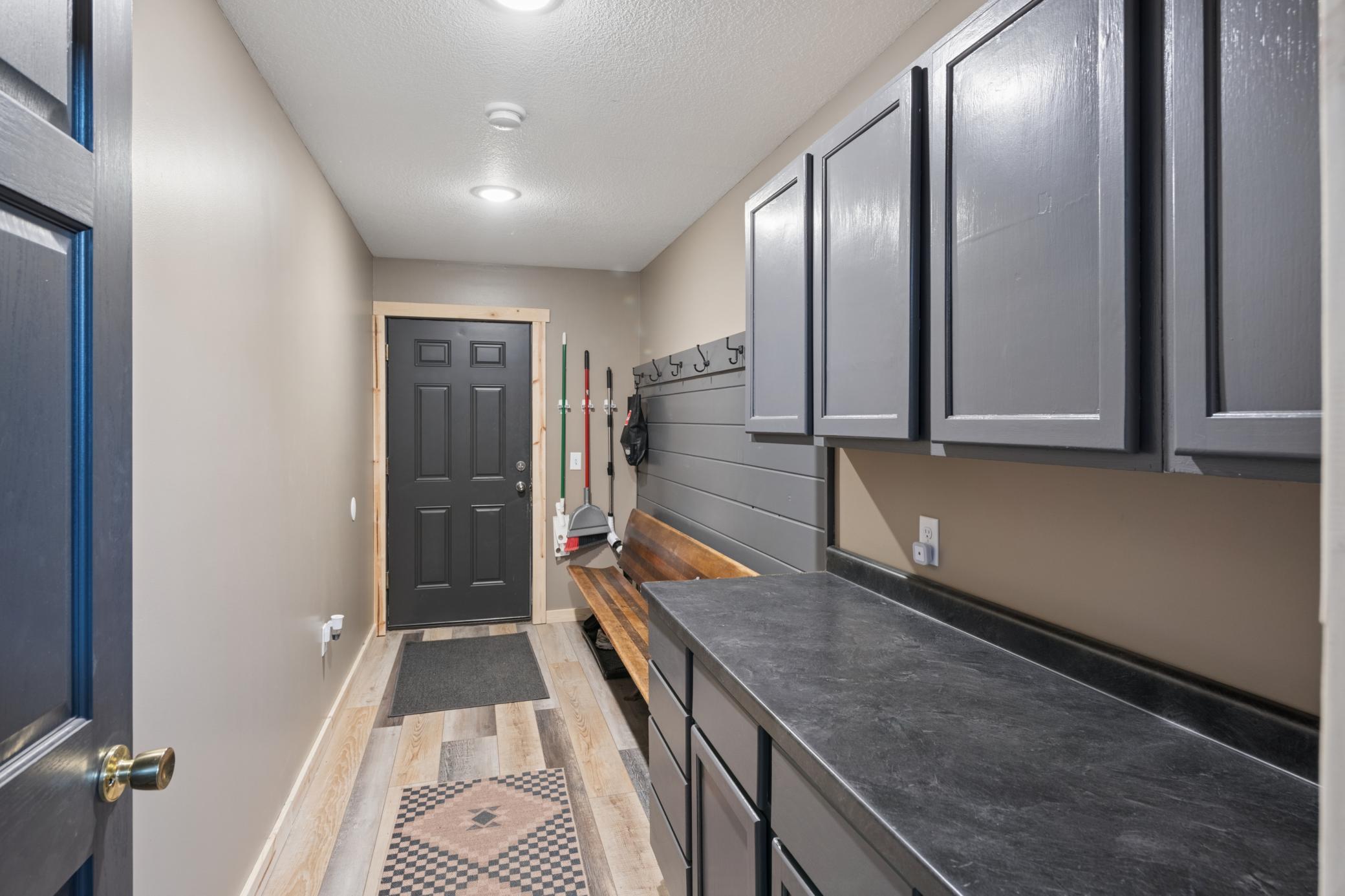 Rear Foyer with bench, coat hooks, and storage cabinetry