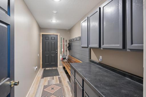 Rear Foyer with bench, coat hooks, and storage cabinetry
