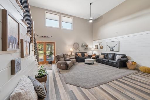 2-story Great room with shiplap wall treatments and open stairway... French doors open to the Screen Porch!