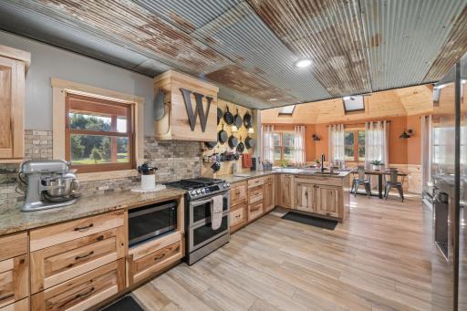 Rustic patina ceiling treatment and Vinyl plank flooring accent the kitchen