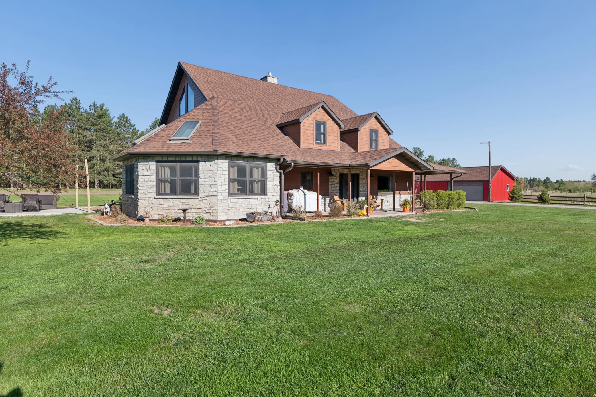 Exterior stone accents, landscaping, and whole housegutters