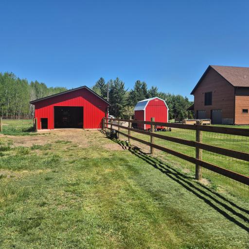 Shop building with side door to fenced in pasture