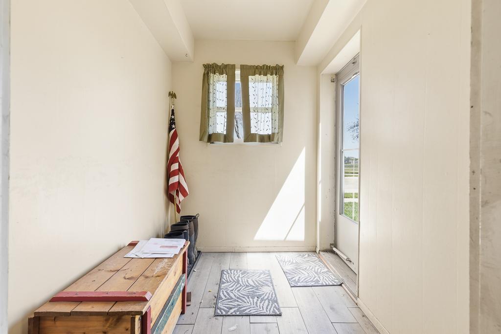 Enclosed front porch perfect for greeting guests! Such a fun and easy space to jazz up!