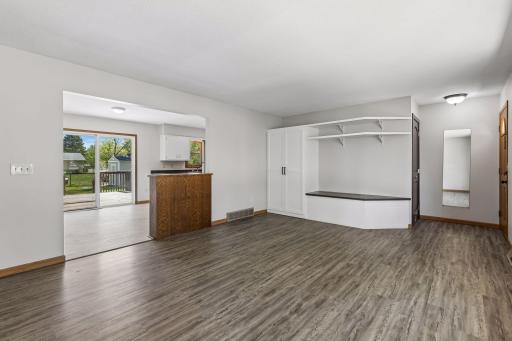 The open main-level layout creates an easy flow from the living room into the informal dining and kitchen. A custom-built-in bench with storage provides a functional everyday drop zone. The main level has been freshly painted.
