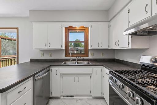 Ample counter space and a kitchen window that overlooks the backyard. The kitchen also has a pantry, an additional storage closet, and access to the garage.