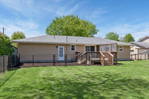 A separate fenced dog run area is adjacent to the deck with a separate set of steps. This area could also serve as a play space, a future deck extension, or a patio. Mature lilac bushes create a beautiful natural border and add seasonal privacy.