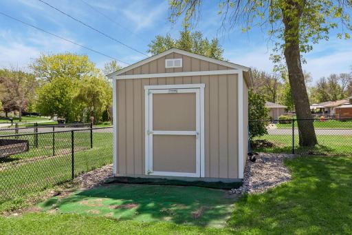 A large storage shed in the rear corner of the lot provides ample space for tools and outdoor equipment. Plus, there's a second shed located next to the garage, adding convenient extra storage space at the front of the house.
