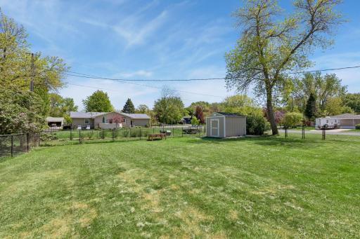 A large, fully fenced backyard offers flexibility and plenty of room for outdoor activities. A double-wide gate makes access into the backyard a breeze.