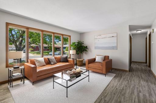 The bright living room welcomes you as you enter and offers a comfortable gathering space filled with natural light. The laminate flooring provides for easy cleaning and maintenance.