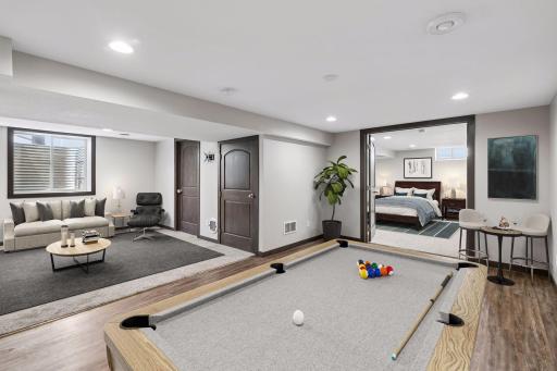 The lower-level layout combines comfort and functionality with multiple usable spaces. The laundry/utility room is located just off the family room, where you will find extra storage, and the recreation space connects to a fourth bedroom!