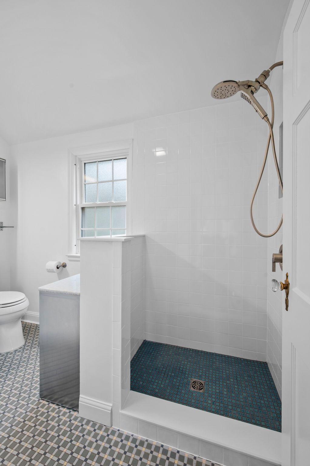 A new glass shower surround will be installed soon.