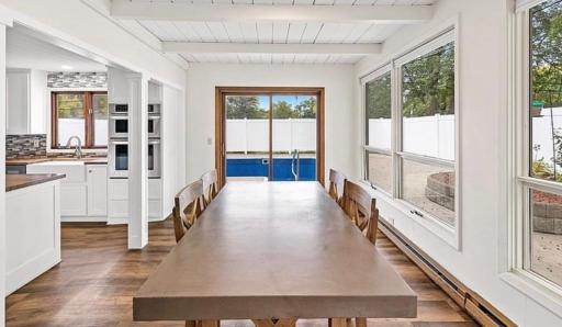 Great light filled dining area that leads out to the pool and patio area.