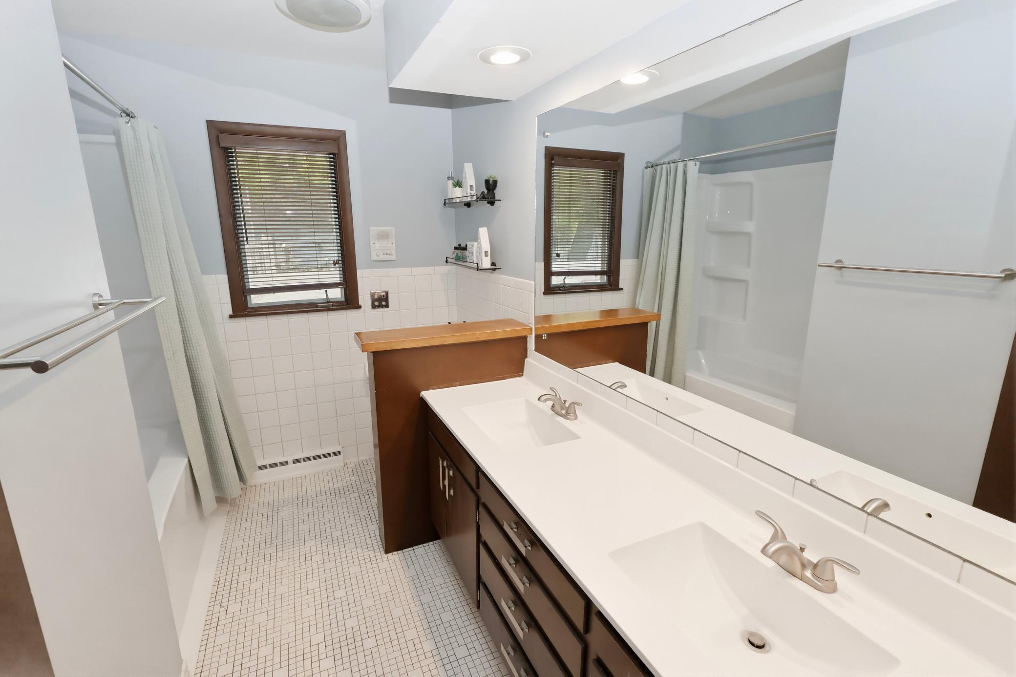 Upper level full bath with double sinks.