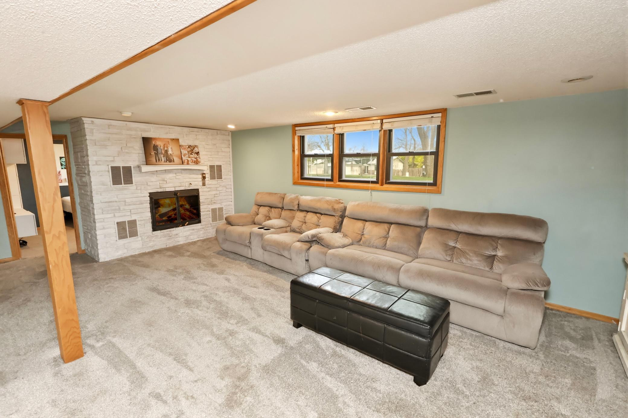 Lower level family room with wood fireplace.