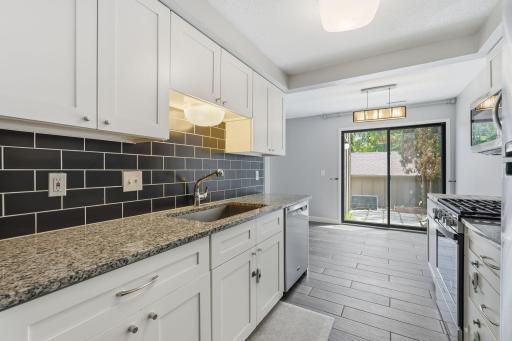 Newer cabinets, granite counter tops, and subway tile backsplash