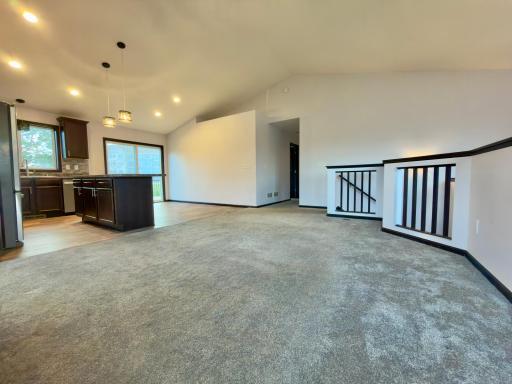 Open Floor plan living leads into kitchen and dining.