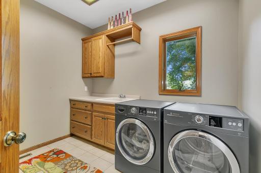 Main floor laundry room with built in storage and work space!
