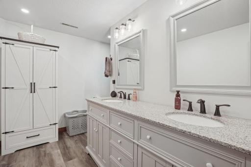 Long counter-top with dual sinks and double mirrors.