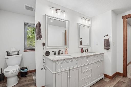 Tucked around the corner is the toilet and shower. Plenty of cabinet and storage space as well.