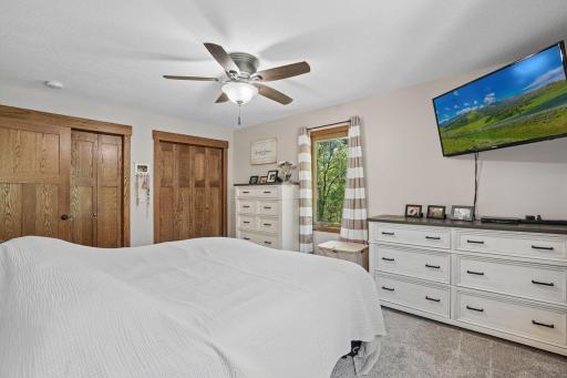 Generous double closets show off rich wood panel doors.