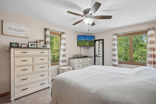 Featuring large windows that frame peaceful wooded views, creating a calming connection to nature and filling the space with beautiful natural light.