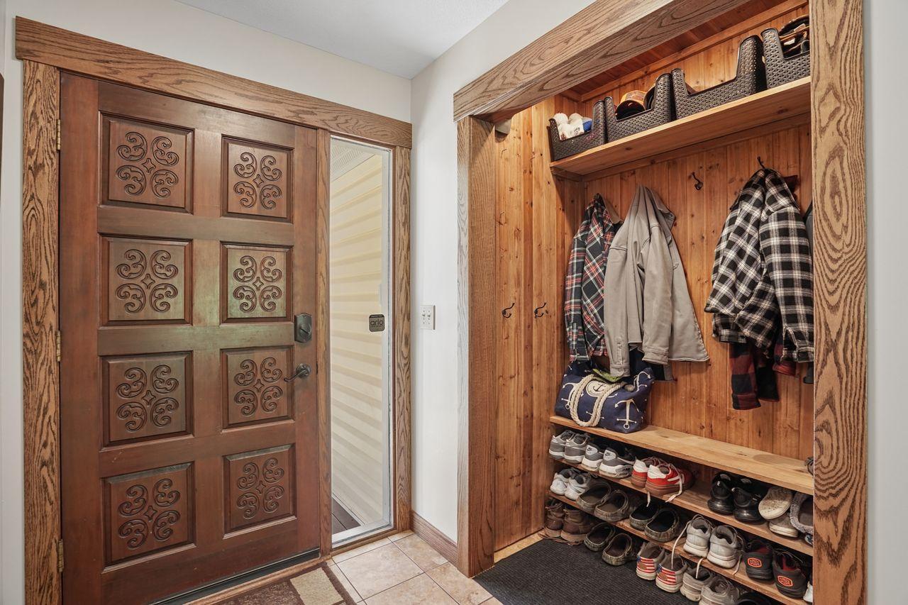 Open-style coat closet, creates both functionality and an inviting sense of openness from the moment you step inside. Built-in coat hooks, upper storage and shoe shelving add to the convenience for MN seasons.