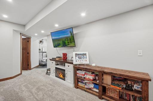 Lots of wall space would easily support a larger TV.