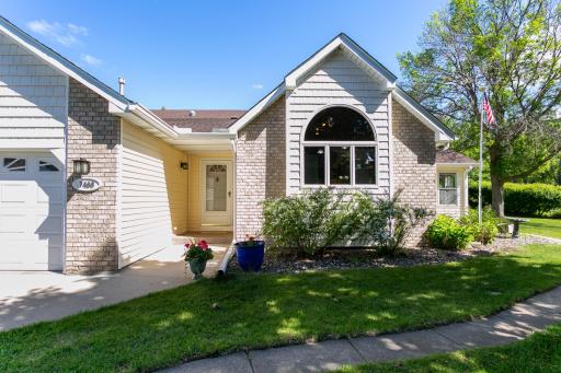 Inviting entrance with a storm door and path to the back