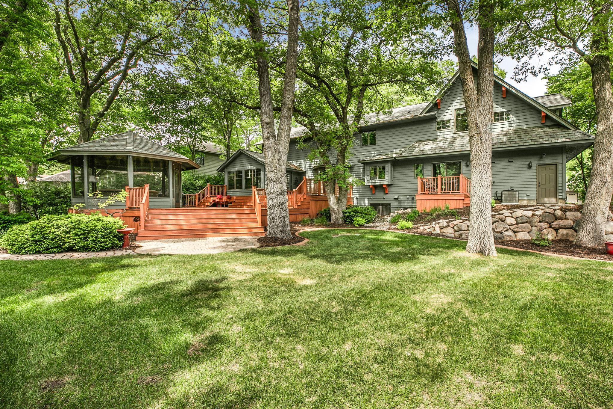 Outdoor living space enhanced by a deck and a private gazebo setting.