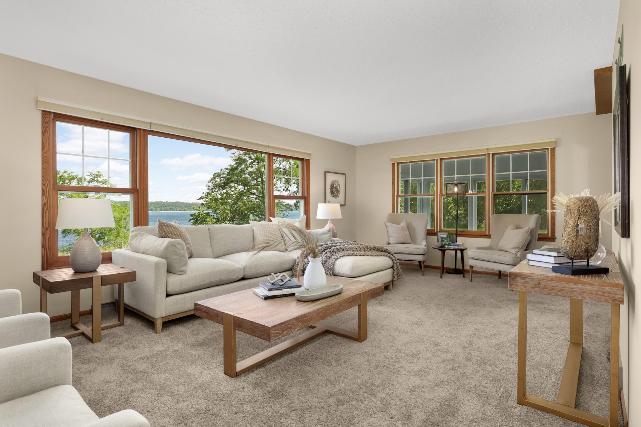 The living room features large windows with expansive views of the river.