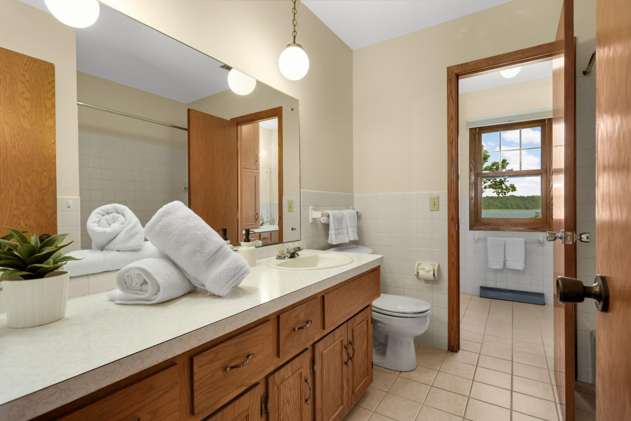 Main floor bathroom with access from primary bedroom and hall.
