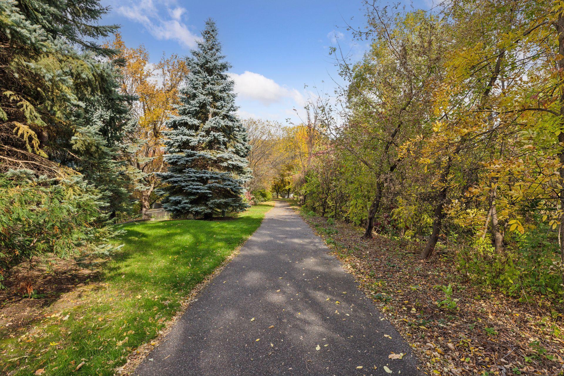 Walking path directly behind the home offers quick access to local Schmidt Lake Park.