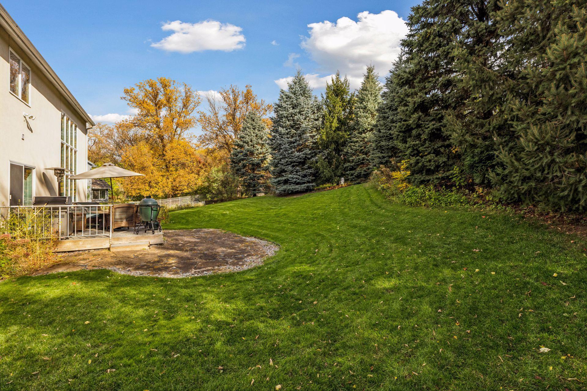 Mature trees frame a private backyard setting.