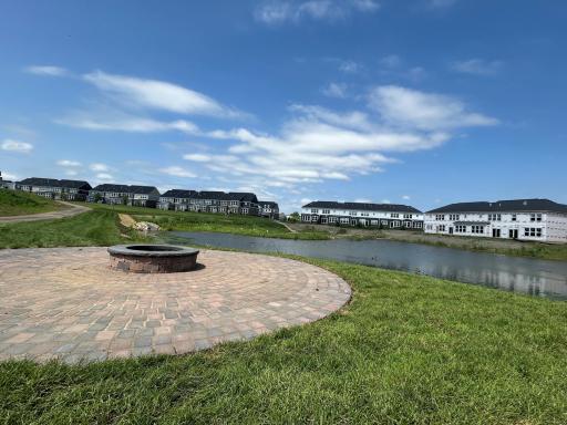 Picturesque neighborhood firepit overlooking pond