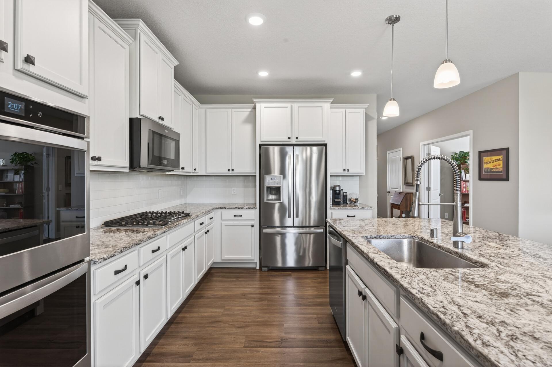 This gleaming kitchen offers tons of cabinetry for all of your kitchen needs. You will love the coffee bar for your morning cup of Joe!